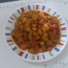 A picture of Ash gourd   tomato curry.