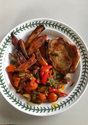 A picture of Pork Loin Chop, Sweet Potato Chips & Sautéed Vegetables.