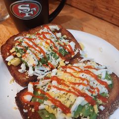 A picture of Avocado toast with grated egg.