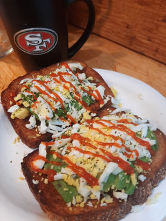 A picture of Avocado toast with grated egg.