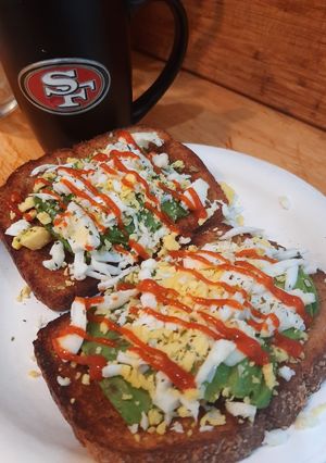 A picture of Avocado toast with grated egg.