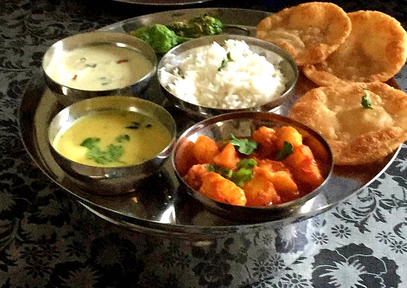 BOILED POTATO CURRY SERVED WITH KADHI, PURI, AND KHEER