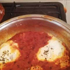 Shakshouka (eggs in tomato and basil sauce) A picture of Shakshouka (eggs in tomato and basil sauce).