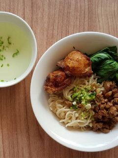 A picture of Egg Noodle With Chicken Pork Chunk And Fried Shrimp Dumplings.