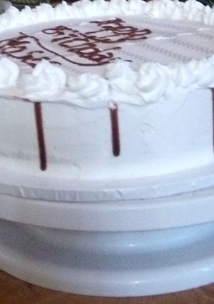 A picture of Vanilla cake with chocolate drip.