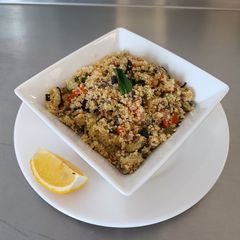 A picture of Couscous Salad with roasted vegetables and mixed herbs.