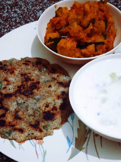 A picture of Swaang atta Aloo Paratha with pumpkin sabzi and aloo raita.