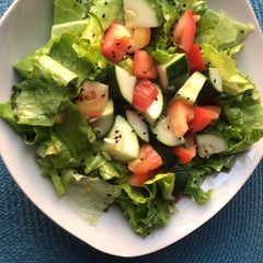 A picture of Salad with homemade dressing.