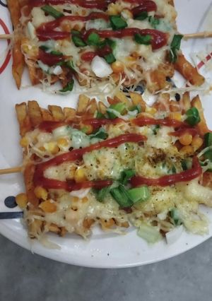 A picture of French fries pizza.