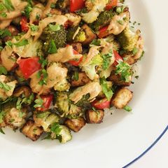A picture of Crispy baked tofu with roasted vegetables and peanut butter sauce.