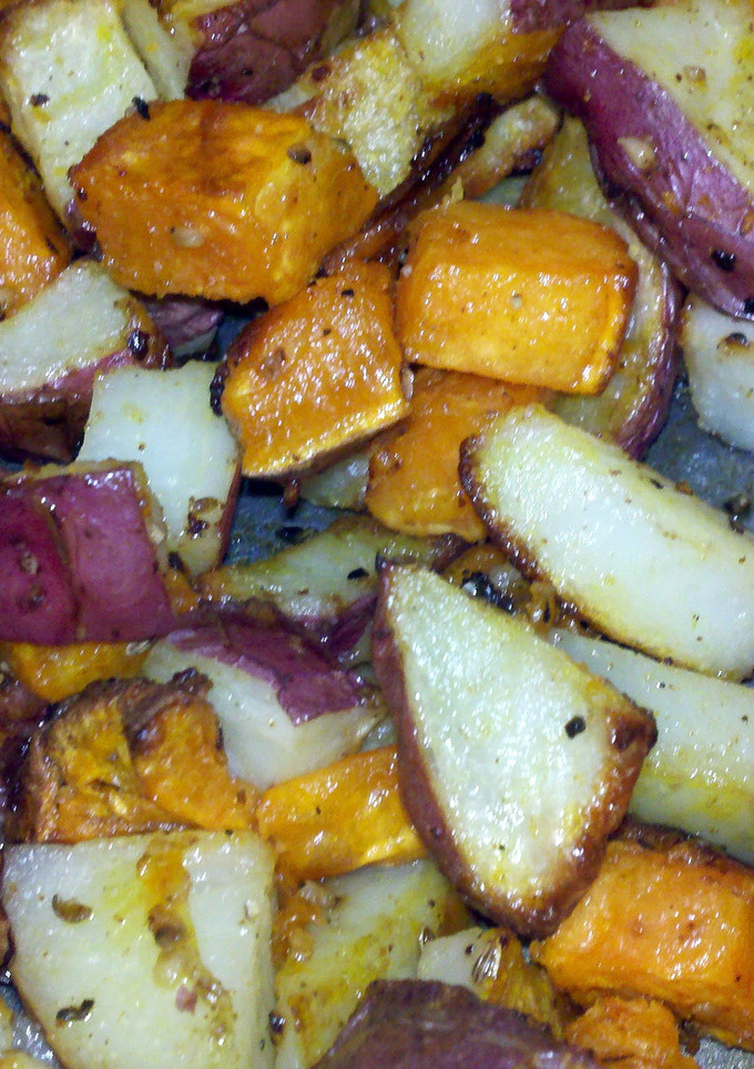 A picture of roasted red and sweet potatoes.