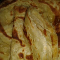 Chapati (Soft, layered) served with coconut beans A picture of Chapati (Soft, layered) served with coconut beans.