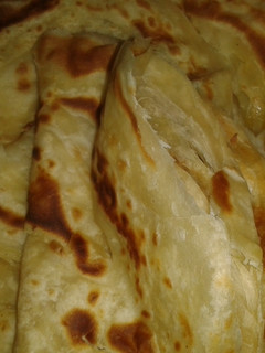 A picture of Chapati (Soft, layered) served with coconut beans.
