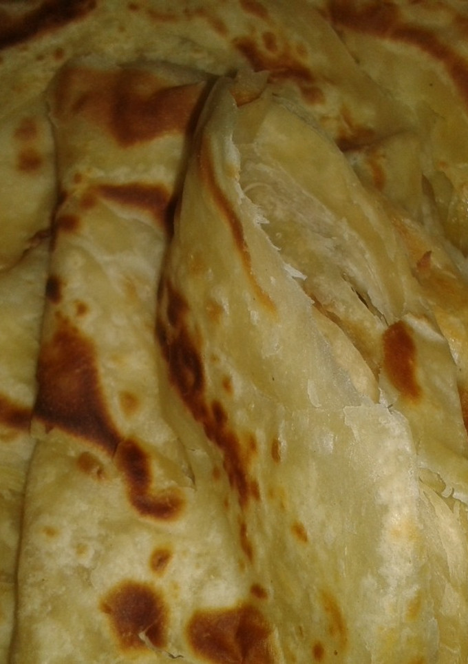 A picture of Chapati (Soft, layered) served with coconut beans.