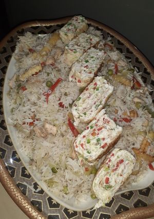 A picture of Chinese Rice with Korean Egg Rolls.