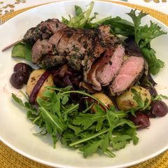A picture of Herby Lamb Leg Steak with Homemade Cherry and Potato Salad.
