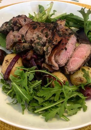 A picture of Herby Lamb Leg Steak with Homemade Cherry and Potato Salad.