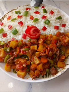 A picture of Garnished white rice with Potato soup.