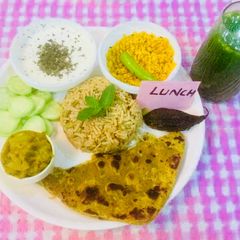 A picture of Veg Brown Rice,bottle gourd sabji,dry urad dal,mint Raita,multigrain dal parantha,green vegjuice.