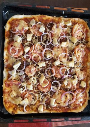A picture of Home made meat deluxe pizza.