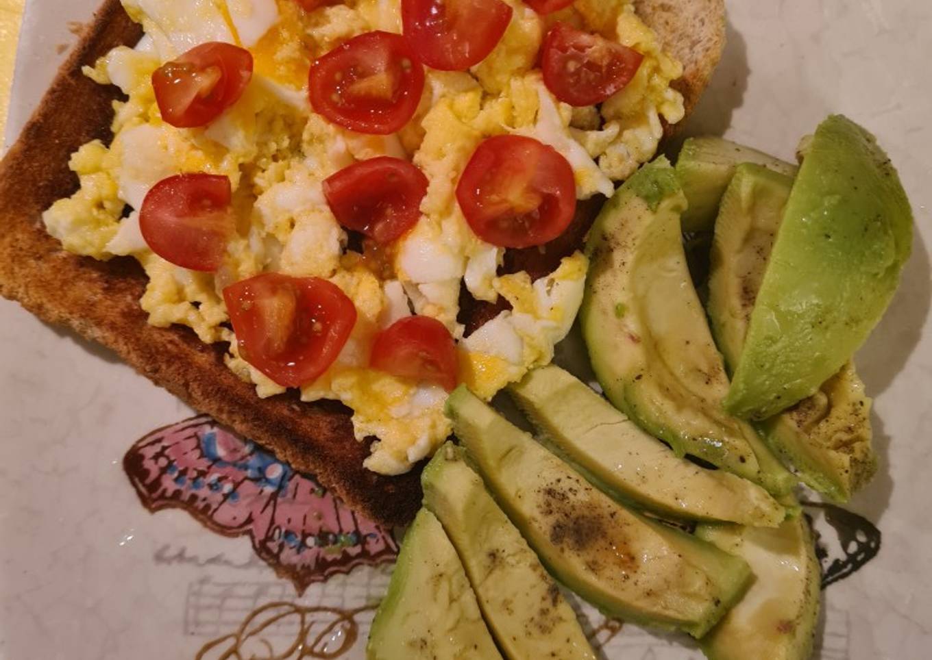 Scrambled eggs on toast and avocado