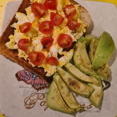 Scrambled eggs on toast and avocado A picture of Scrambled eggs on toast and avocado.