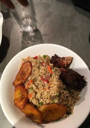 A picture of Vegetable jollof rice and plantain.