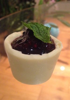 A picture of Solid white chocolate pots with blackberry and mint compote.