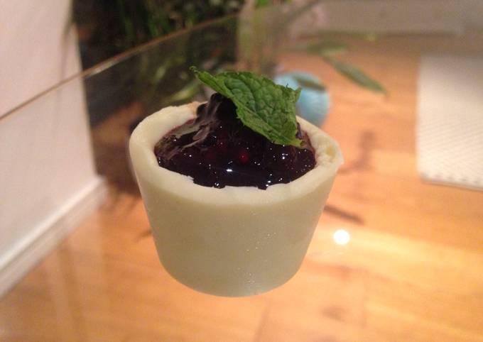 Solid white chocolate pots with blackberry and mint compote