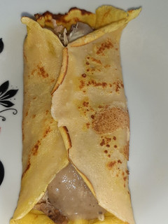 Una foto de Crepa rellena de recalentado de chancho al horno