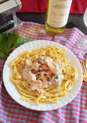 A picture of Turkey strips with mushroom and spinach in creamy sauce on a bed of homemade Tagliatelle.