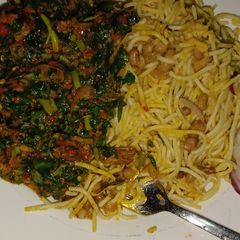 A picture of Bean and spaghetti with waterleaf sauce.
