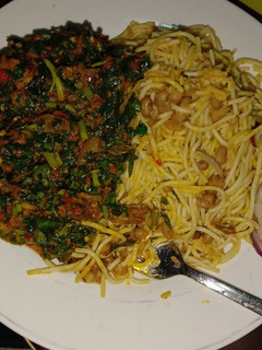 A picture of Bean and spaghetti with waterleaf sauce.