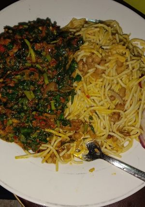 A picture of Bean and spaghetti with waterleaf sauce.