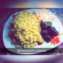 A picture of Jollof rice with coleslaw.