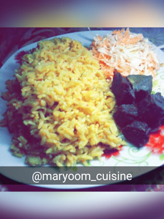 A picture of Jollof rice with coleslaw.