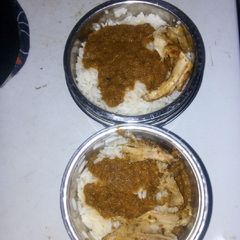 A picture of Rice and stew with chicken.