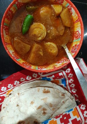 A picture of Aloo anday ka salan with tandoori roti.
