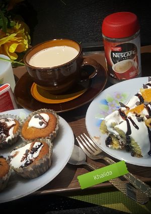 A picture of CHOCOLATE CHIP ORANGE SWISS ROLL, CUP CAKES AND MILK COFFEE.