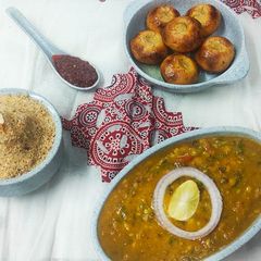 A picture of Dal baati churma with garlic chutney.