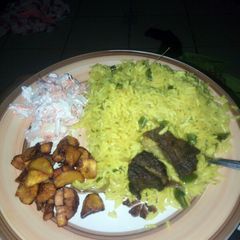 A picture of Fried rice,plantain and coleslaw.