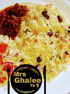 A picture of Veggies rice and stew with salad.