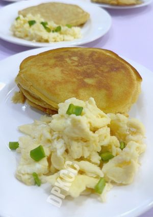 A picture of Scrambled Eggs With Fluffy Pancakes.