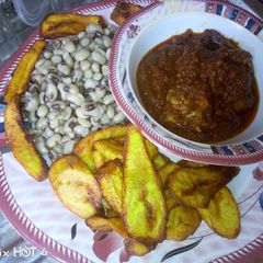 A picture of Fried plantain,boiled beans and fish stew.