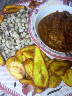 A picture of Fried plantain,boiled beans and fish stew.