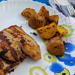 A picture of Grilled fish with roasted potato.