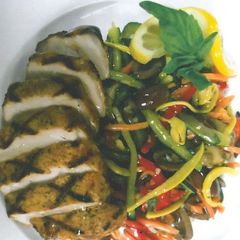 A picture of Boneless Grilled Pork Loin with Organic Local Zesty Skillet Vegetables.