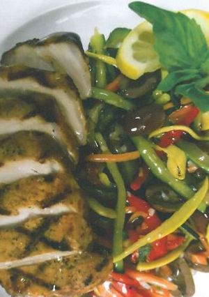A picture of Boneless Grilled Pork Loin with Organic Local Zesty Skillet Vegetables.