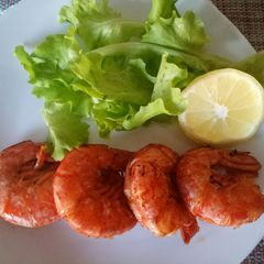 A picture of Pan fried king prawns with paprika and lemon.
