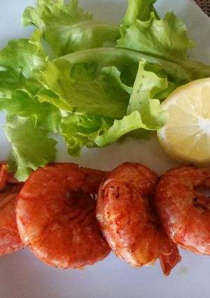 A picture of Pan fried king prawns with paprika and lemon.